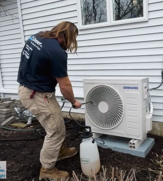 Technician inspecting heat pump cooling equipment