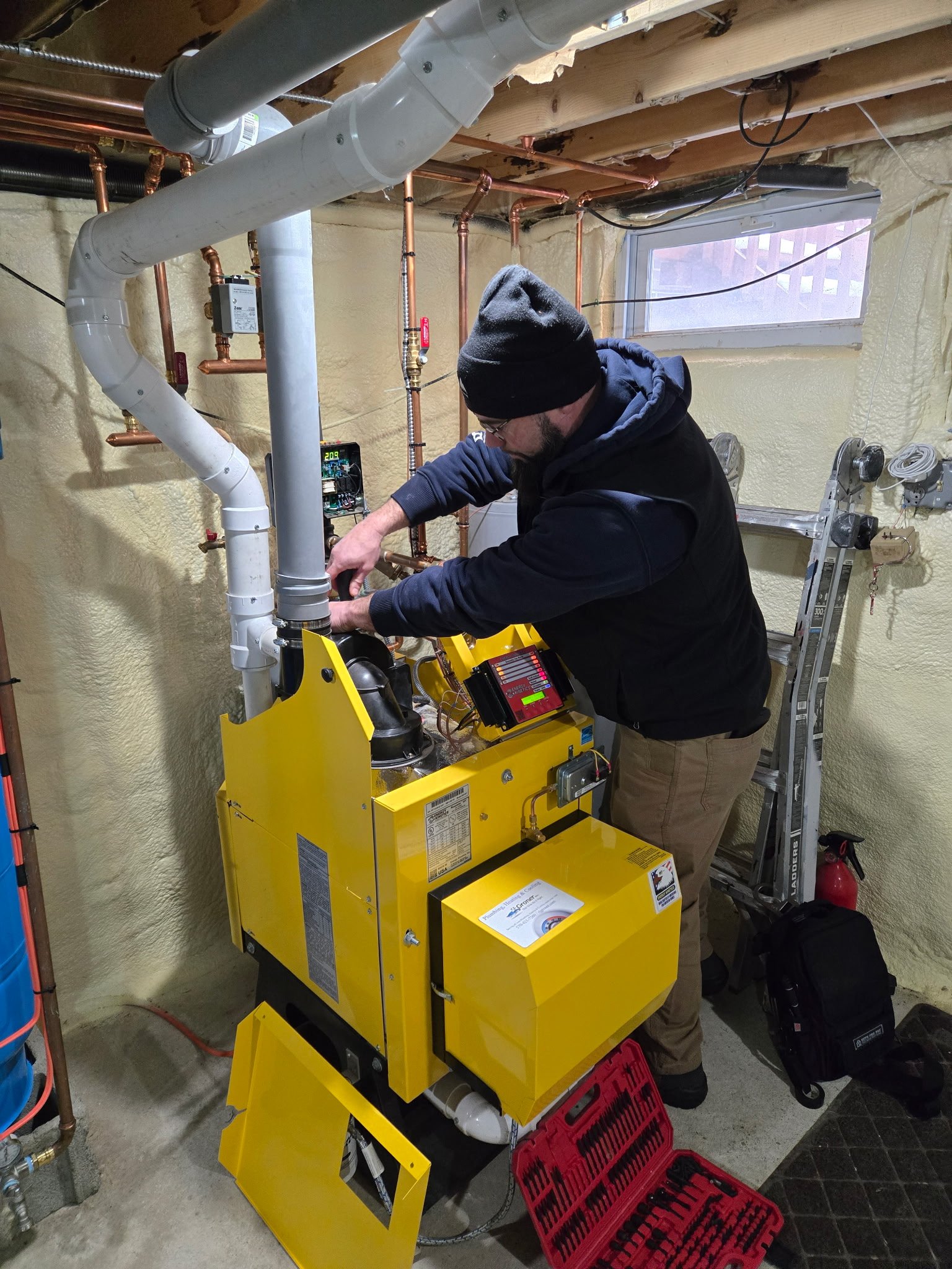 Technician servicing a home boiler